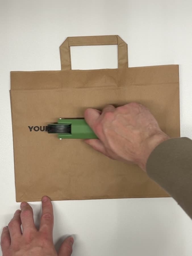 RollerMark printing a custom logo on a kraft paper bag